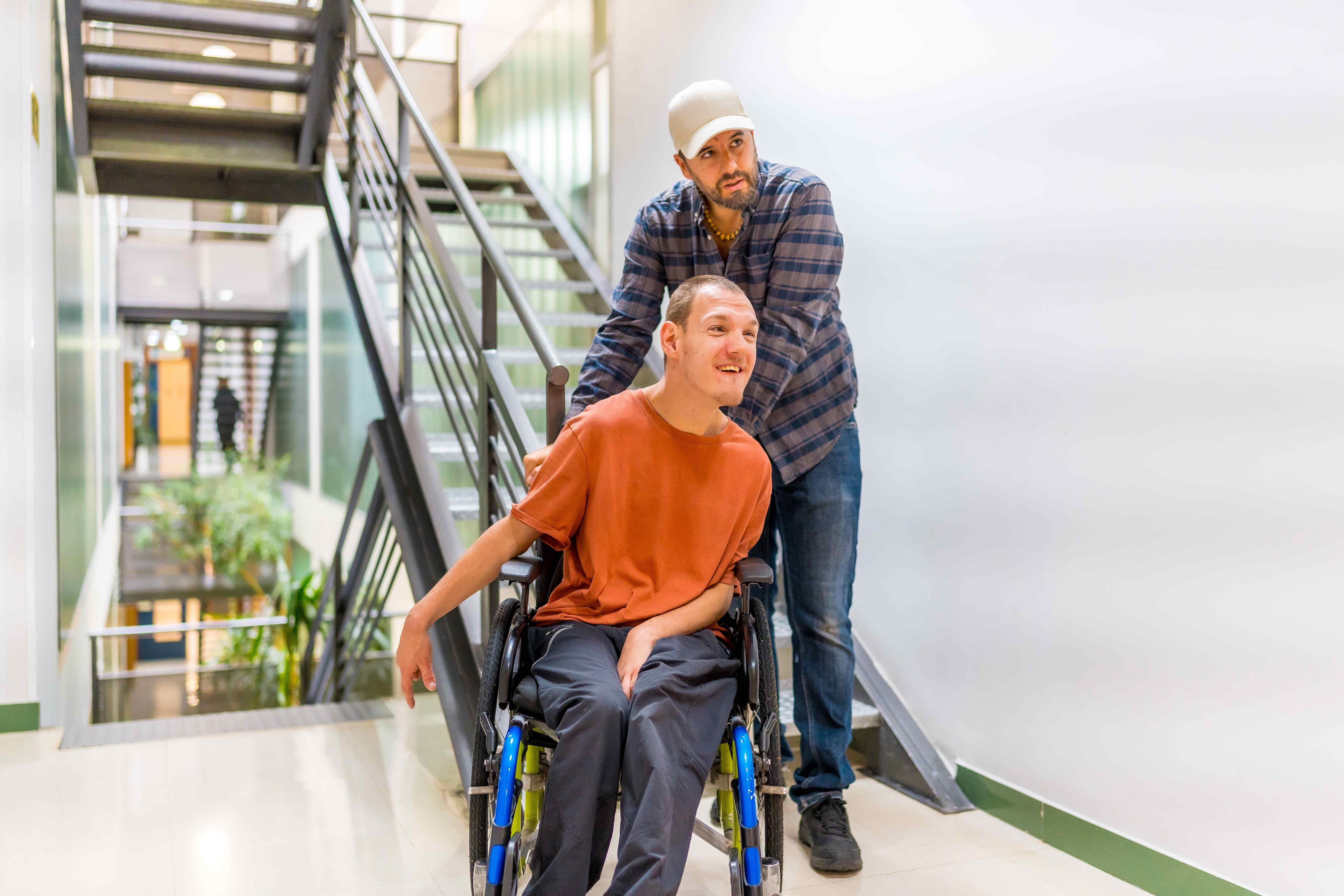 Support worker assisting a person in a wheelchair